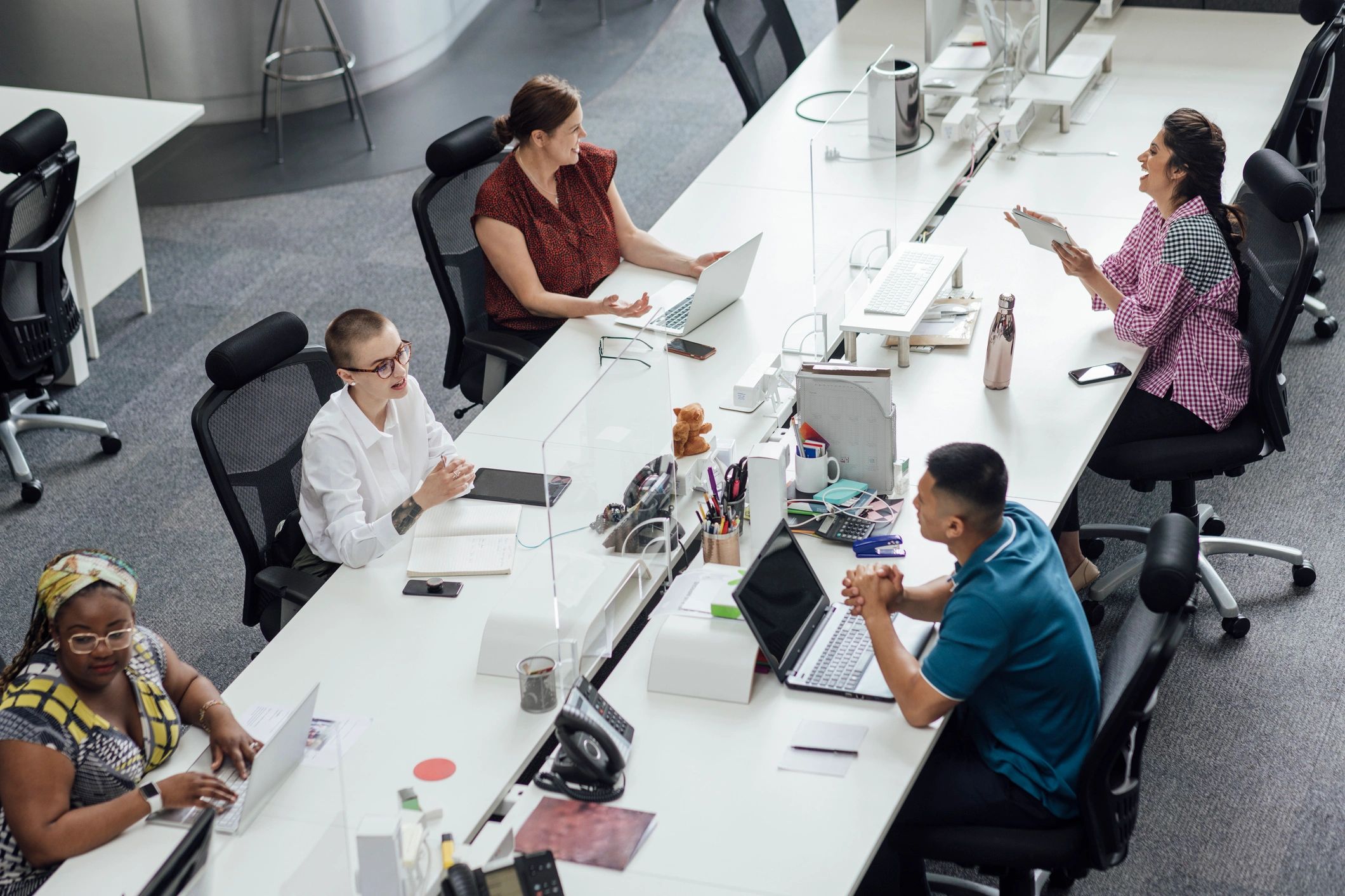 Professionals reviewing business information in a newsroom-style office