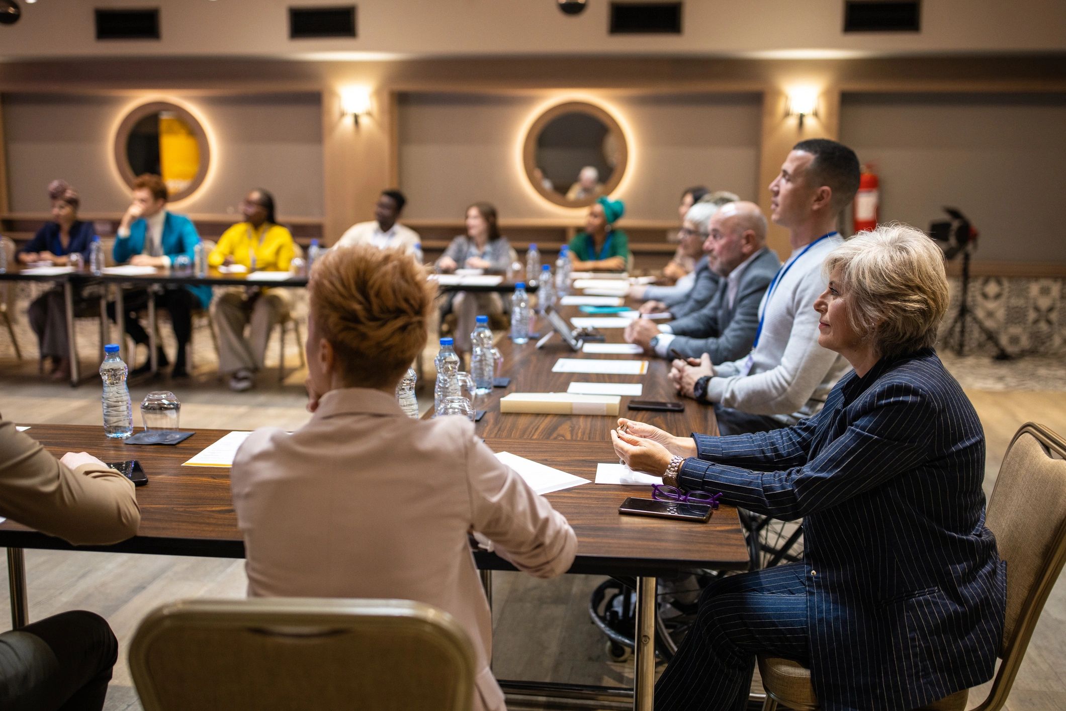 Audience attending a formal press-style conference event