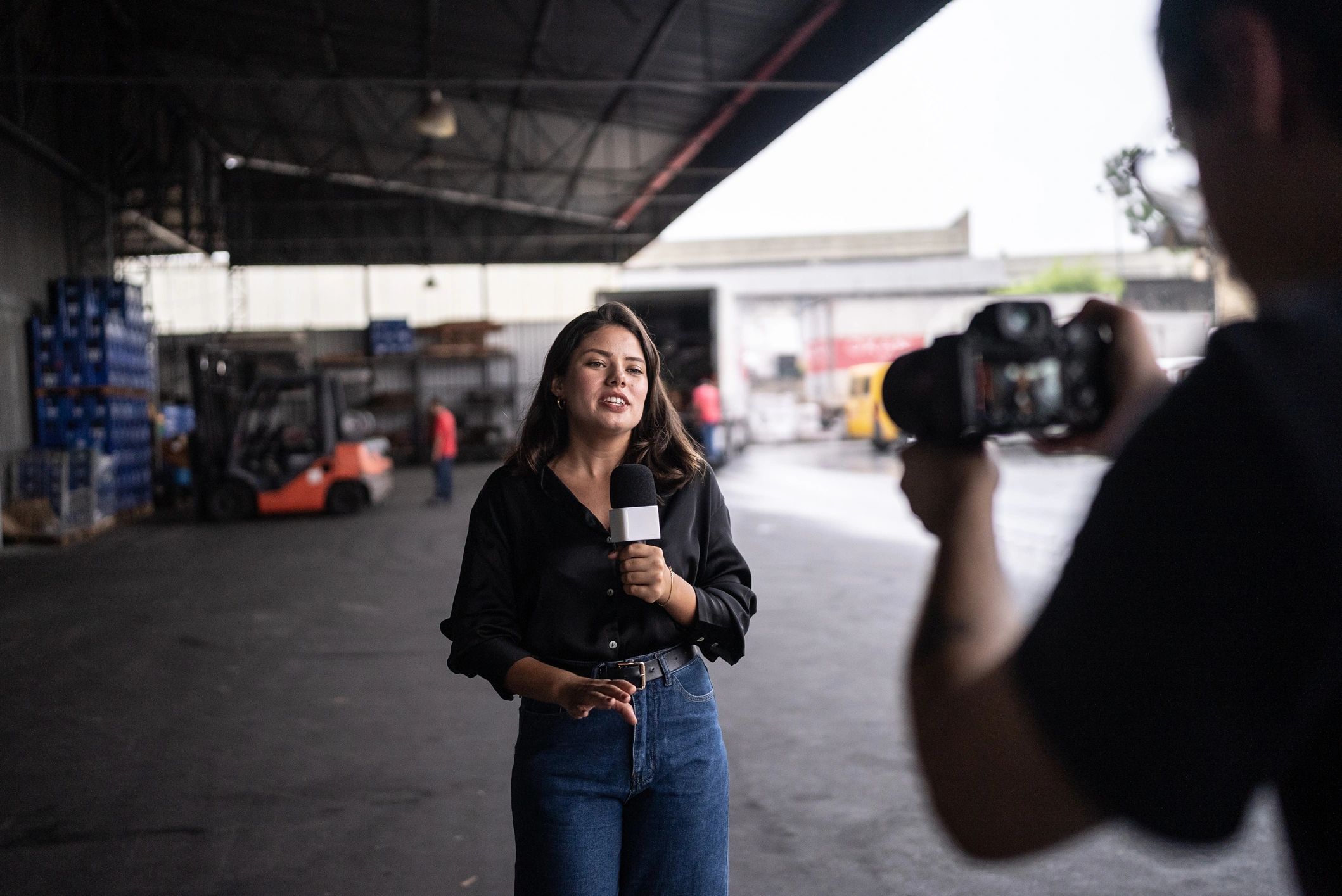 Reporter speaking on microphone on location