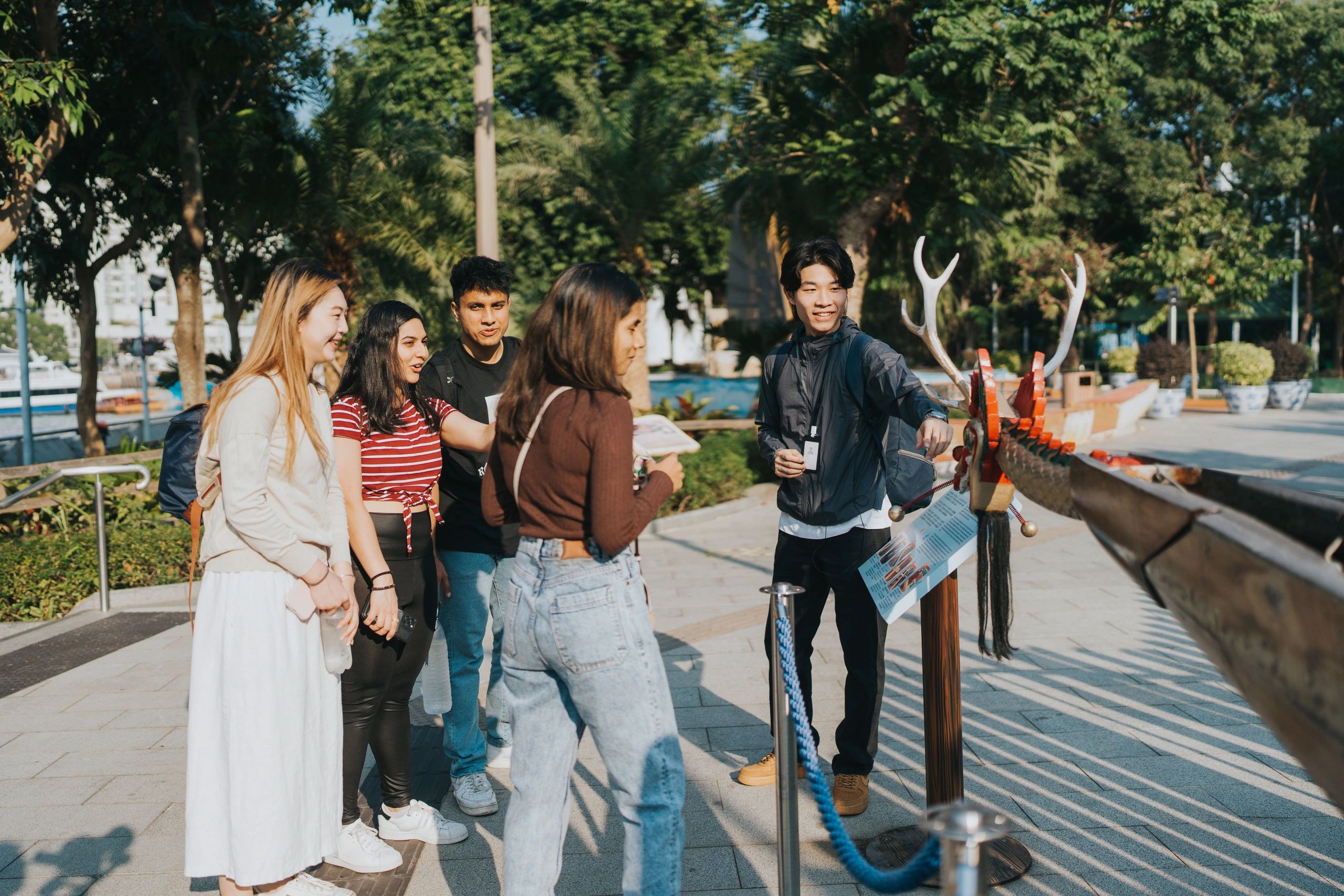 Field guide speaking to a mixed group during an on-location reporting style scene