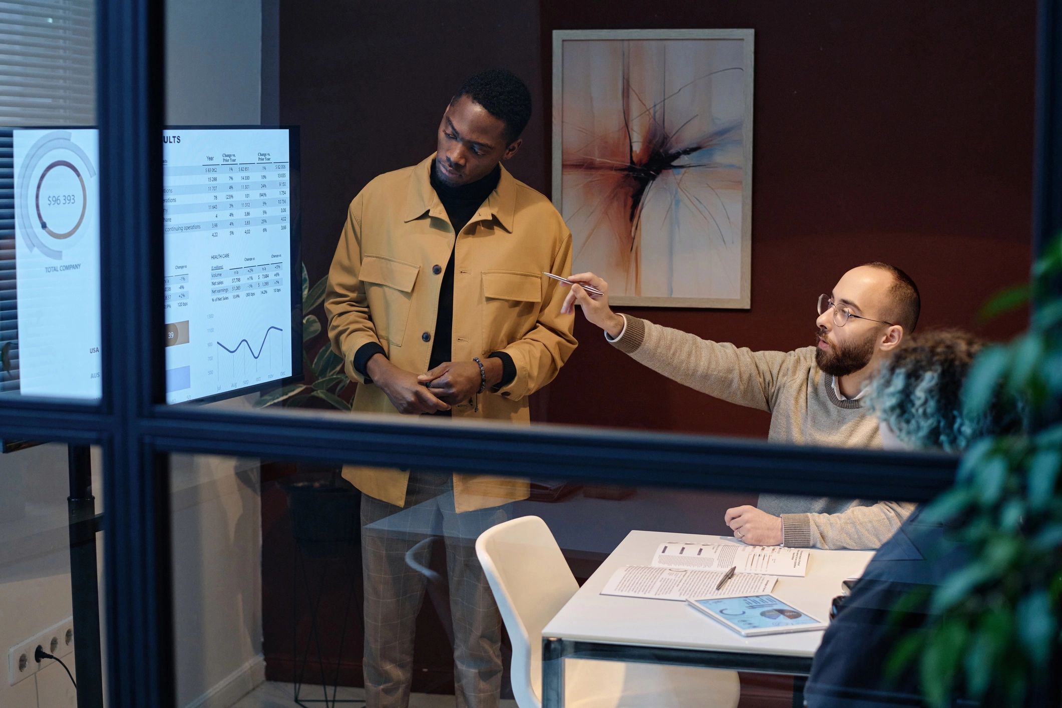 Editorial team reviewing information and data together in a newsroom meeting