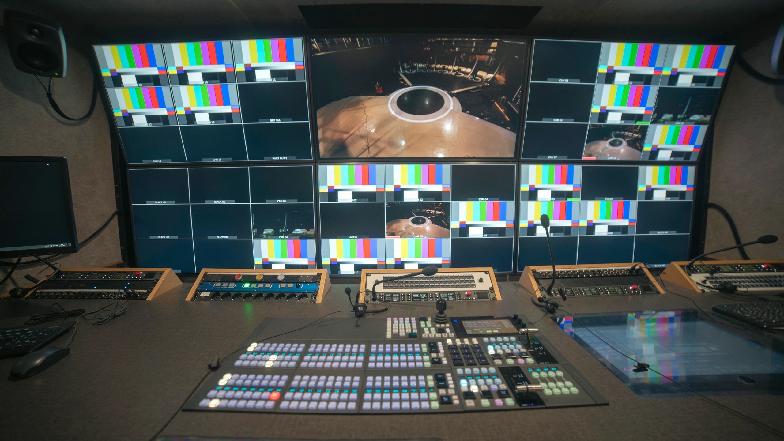 Professional broadcast control room with video switcher and multiview monitors with copy space